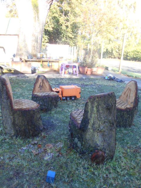 seats carved from logs in a nursery playground